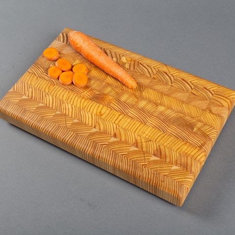 A handmade larch wood end grain cutting board - a classic design with a contemporary look.
