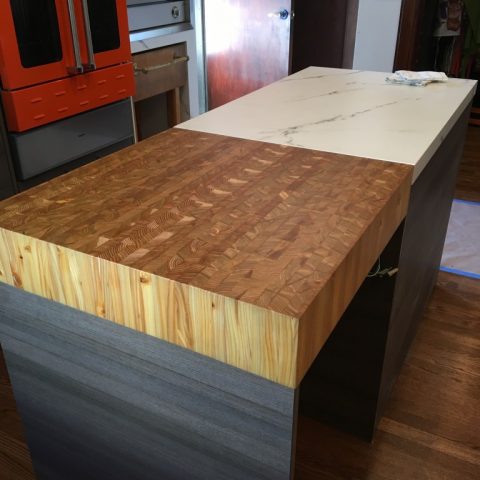 A custom made end grain kitchen chopping block integrated into a marble work surface.